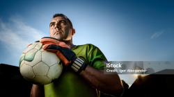 kiper sepak bola melakukan penyelamatan di pertandingan malam